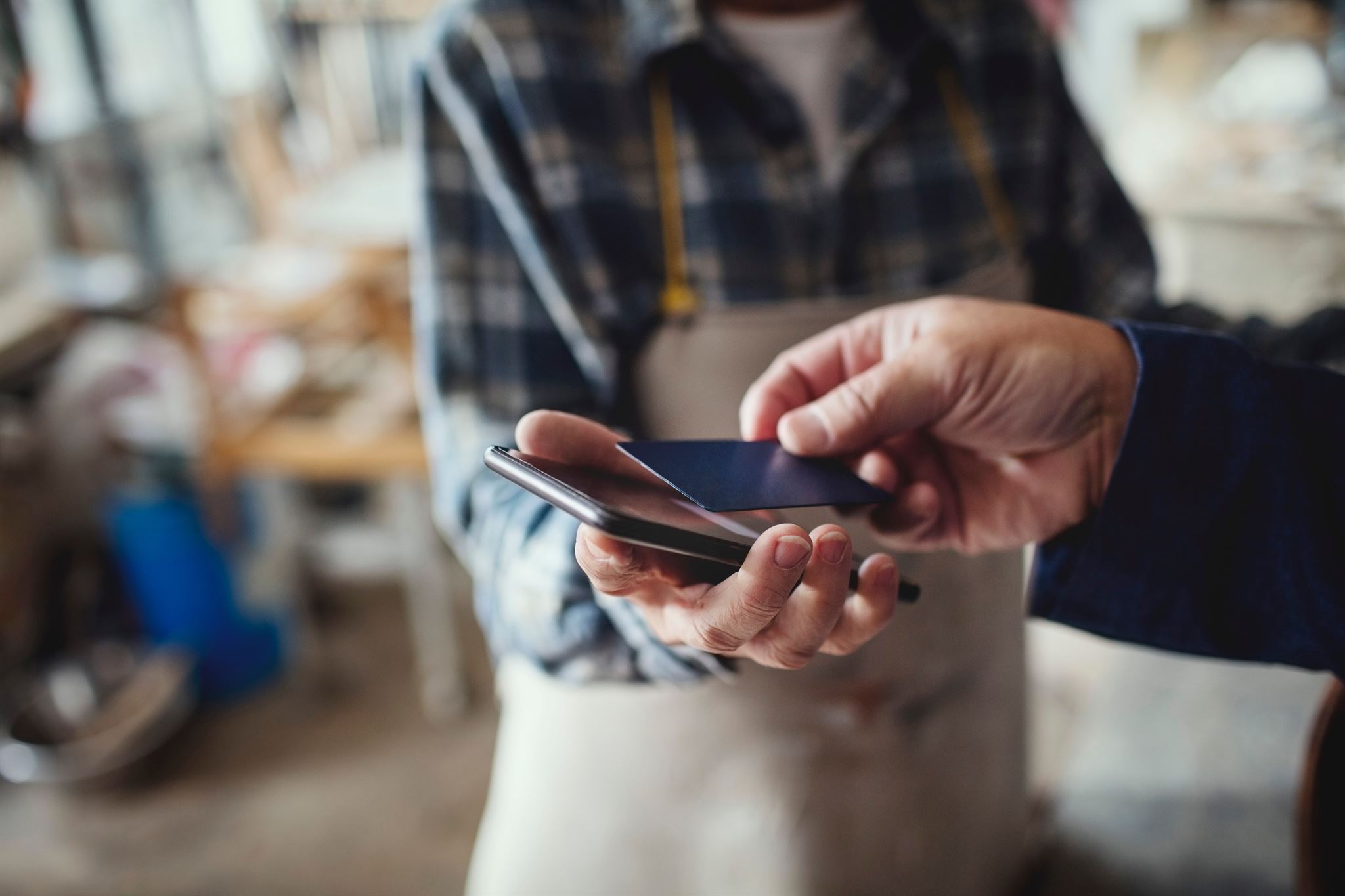 Person-scanning-debit-card-with-phone